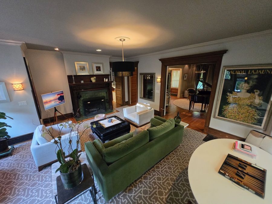 Formal living room with restored fireplace and refinished hardwood floors