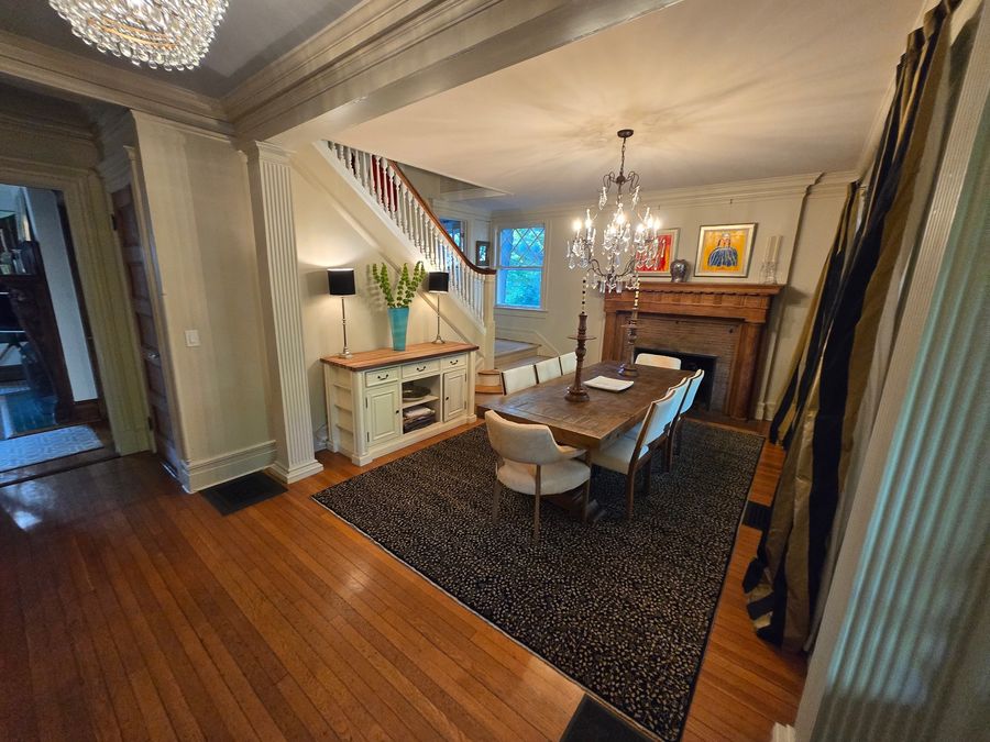 Dining room with restored mantel, staircase and hardwood floors