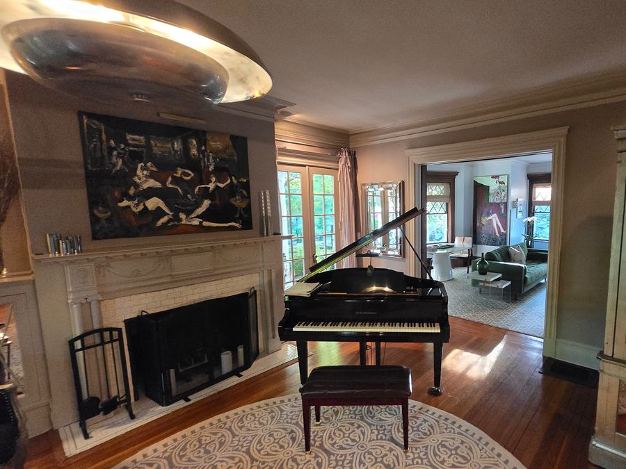 Music room with marble fireplace and French doors