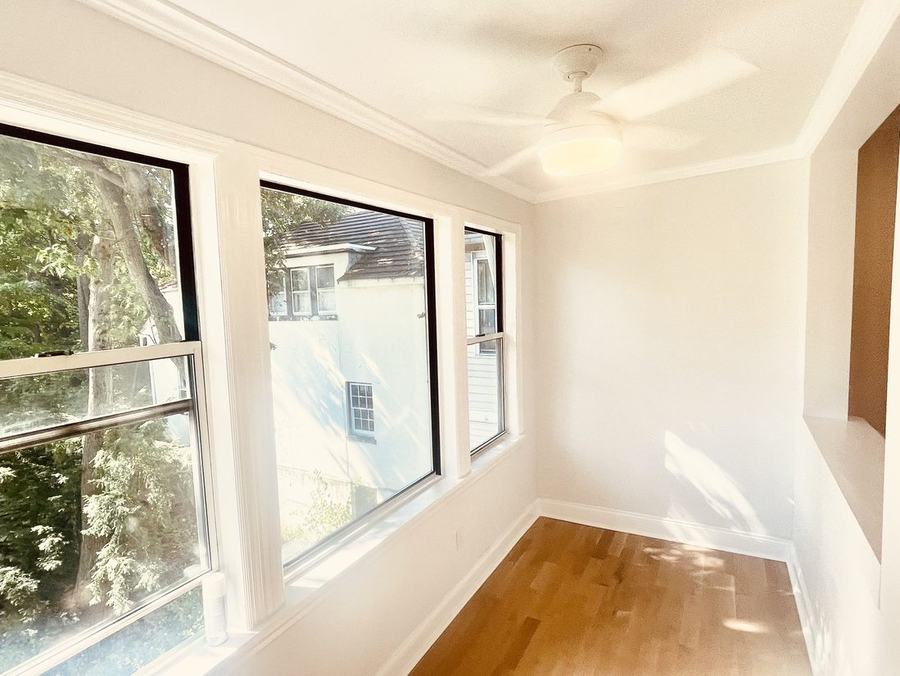 Sun room with wraparound windows after renovation