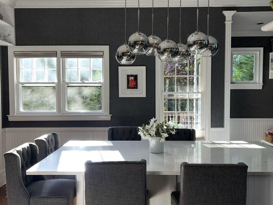 Renovated kitchen with quartz island and chrome pendant lighting