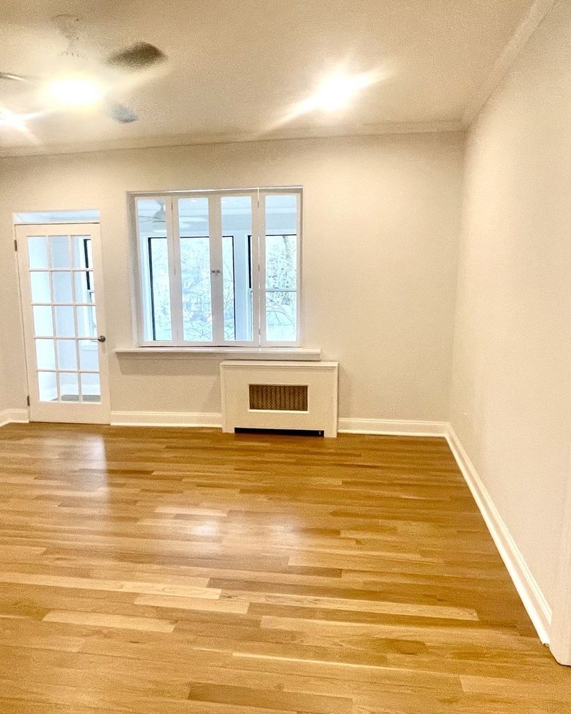 Bright living room with French doors, prepared for a new tenant