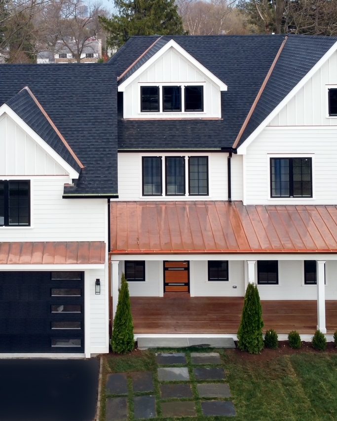 Completed whole-home rebuild with standing-seam copper porch roof, Westchester County
